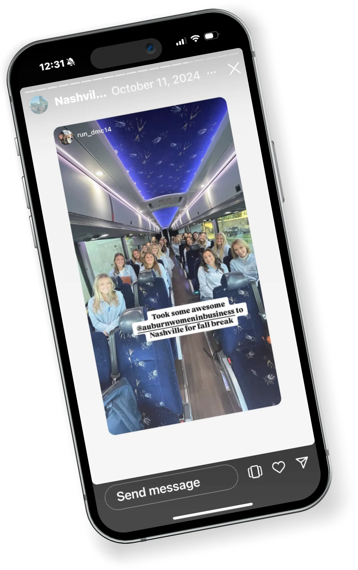 A smartphone displays an Instagram story of a group of women from Auburn Women in Business smiling on a bus during a trip to Nashville.